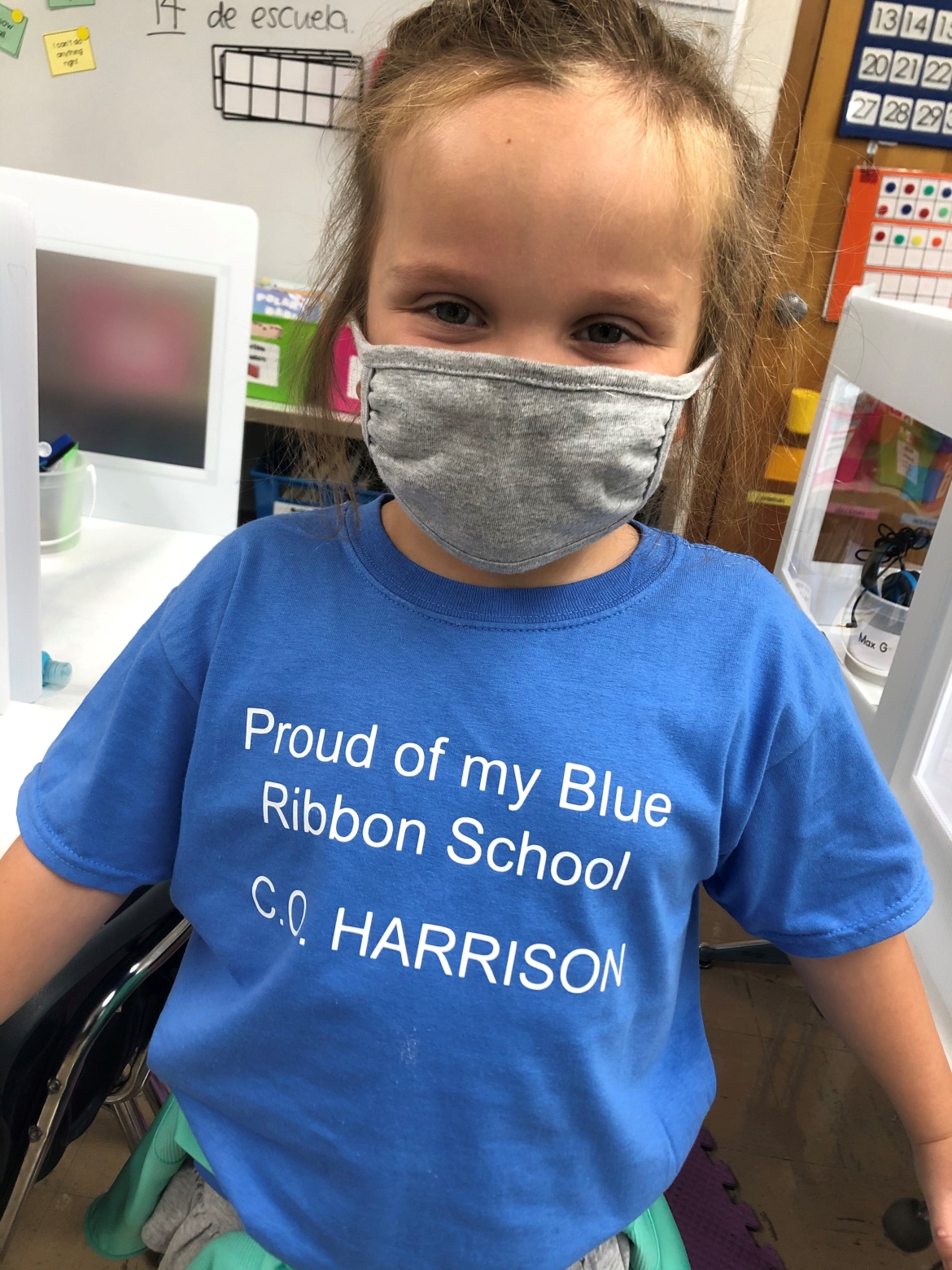 Kid wearing C.O Harrison blue ribbon shirt